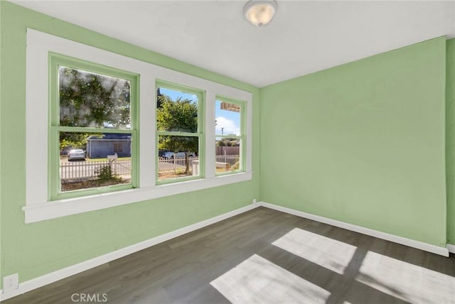 spare room with dark hardwood / wood-style floors