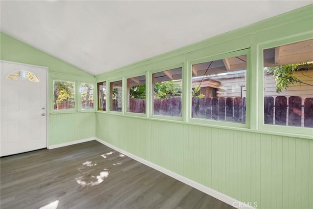 unfurnished sunroom featuring a healthy amount of sunlight and vaulted ceiling