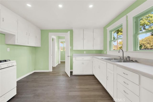 1312 4th, Corning, CA 96021 - kitchen featuring white range with gas stovetop, light countertops, recessed lighting, white cabinetry, and dark wood-style floors