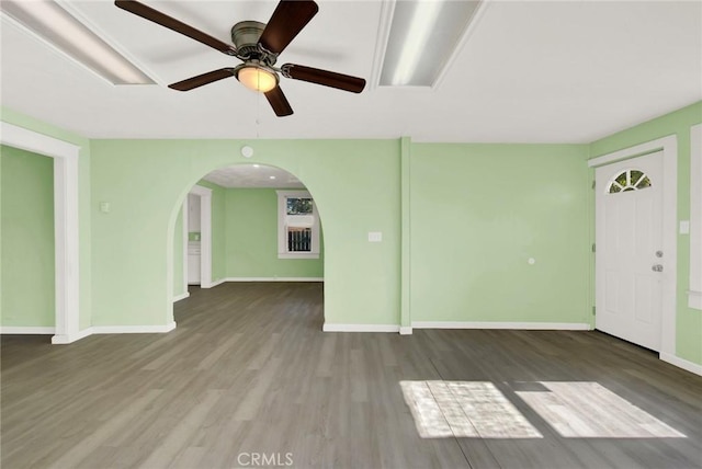 1312 4th, Corning, CA 96021 - unfurnished living room featuring wood finished floors, ceiling fan, and arched walkways