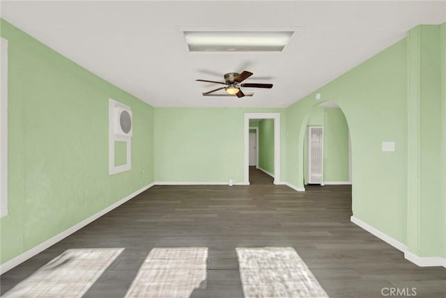 spare room featuring dark hardwood / wood-style floors and ceiling fan