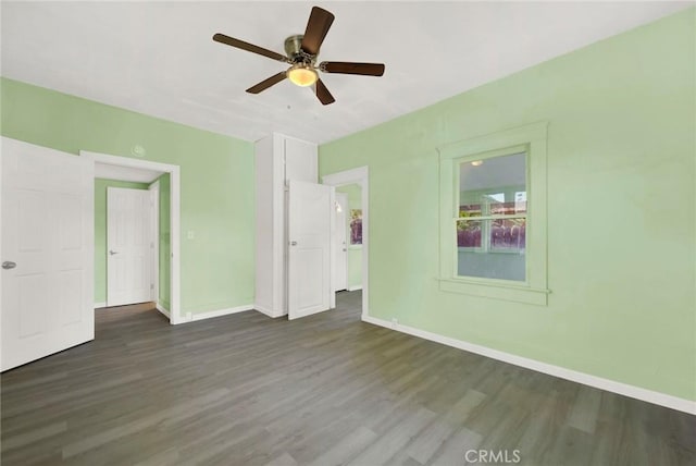 spare room with ceiling fan and dark wood-type flooring