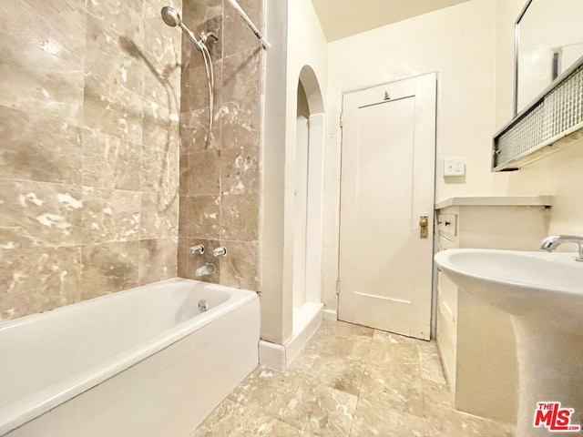 bathroom featuring sink and tiled shower / bath