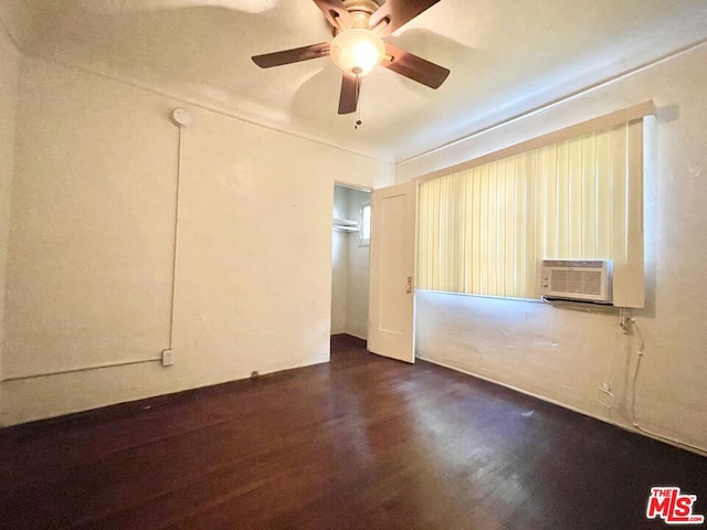 empty room featuring dark hardwood / wood-style flooring, cooling unit, and ceiling fan