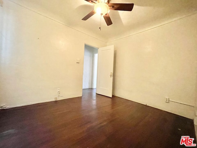 spare room with dark hardwood / wood-style floors and ceiling fan