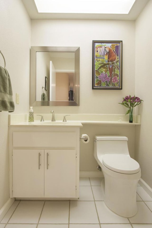 bathroom featuring toilet, vanity, and tile patterned floors