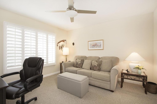 carpeted home office featuring ceiling fan