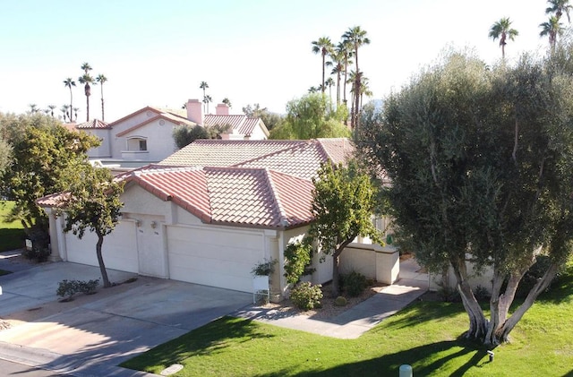 view of front of property featuring a garage and a front lawn