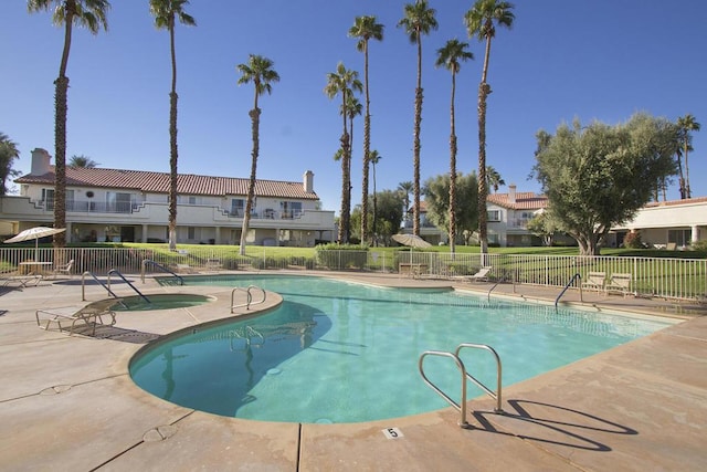 view of pool with a patio and a hot tub