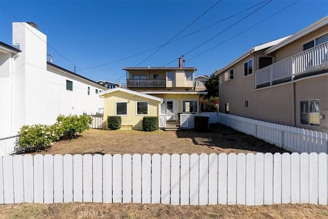 back of house with central AC unit