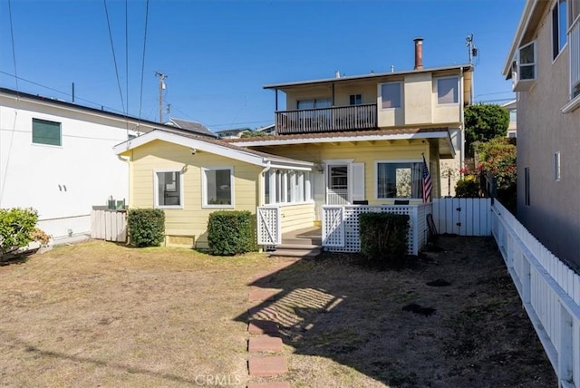 rear view of property with a balcony