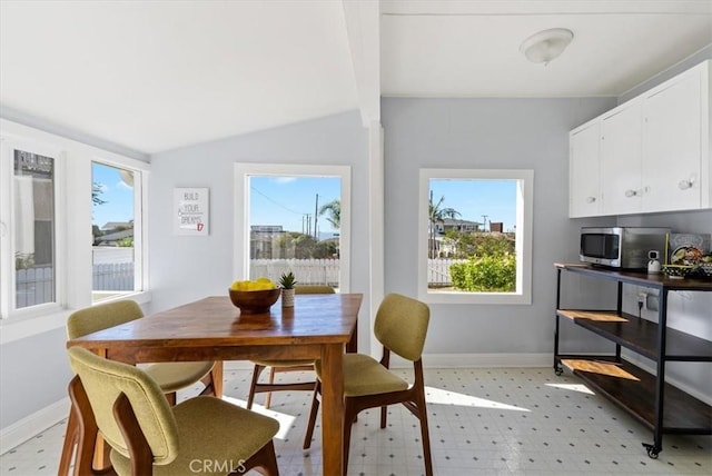 dining area featuring beamed ceiling