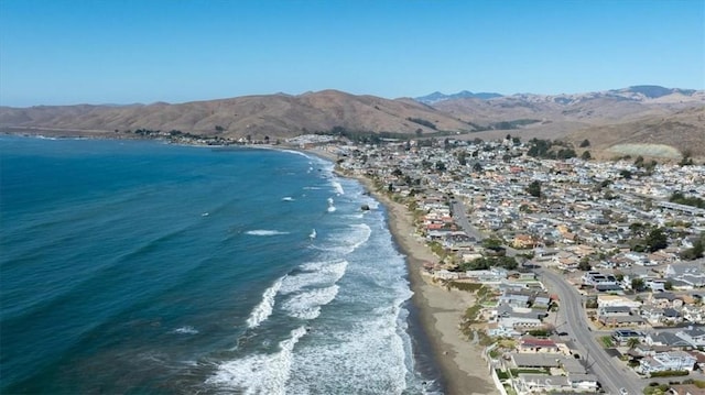 water view featuring a mountain view and a beach view