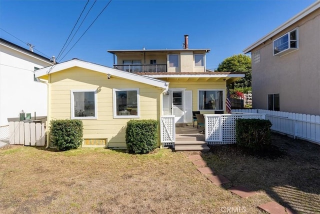 rear view of property with a lawn