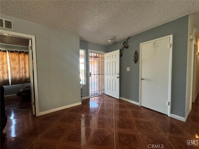 tiled foyer featuring a textured ceiling