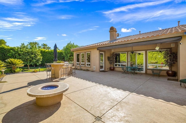 view of patio with a bar and a fire pit