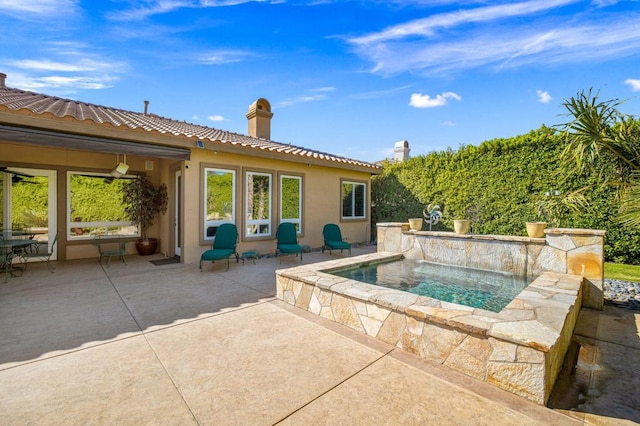 view of swimming pool featuring ceiling fan and a patio area