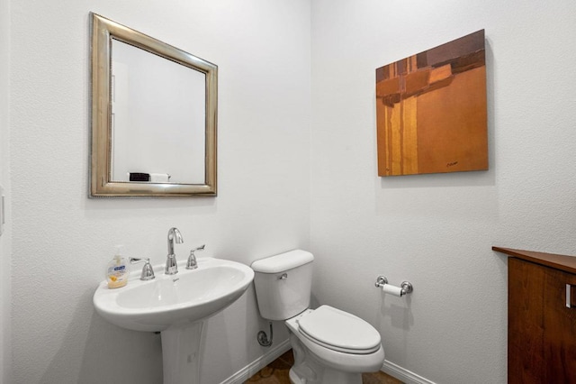 bathroom featuring toilet and sink