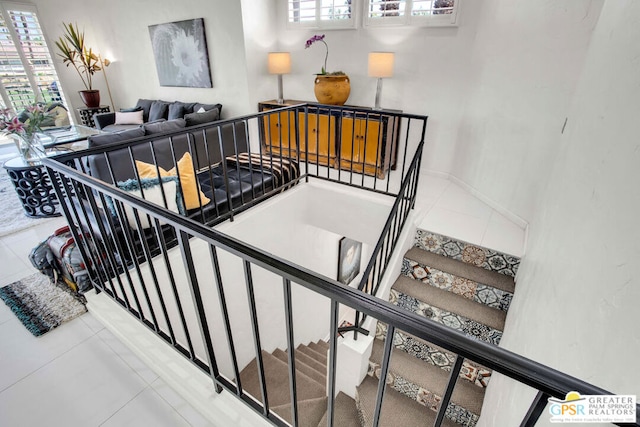 stairway featuring tile patterned flooring