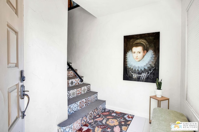 staircase featuring tile patterned floors