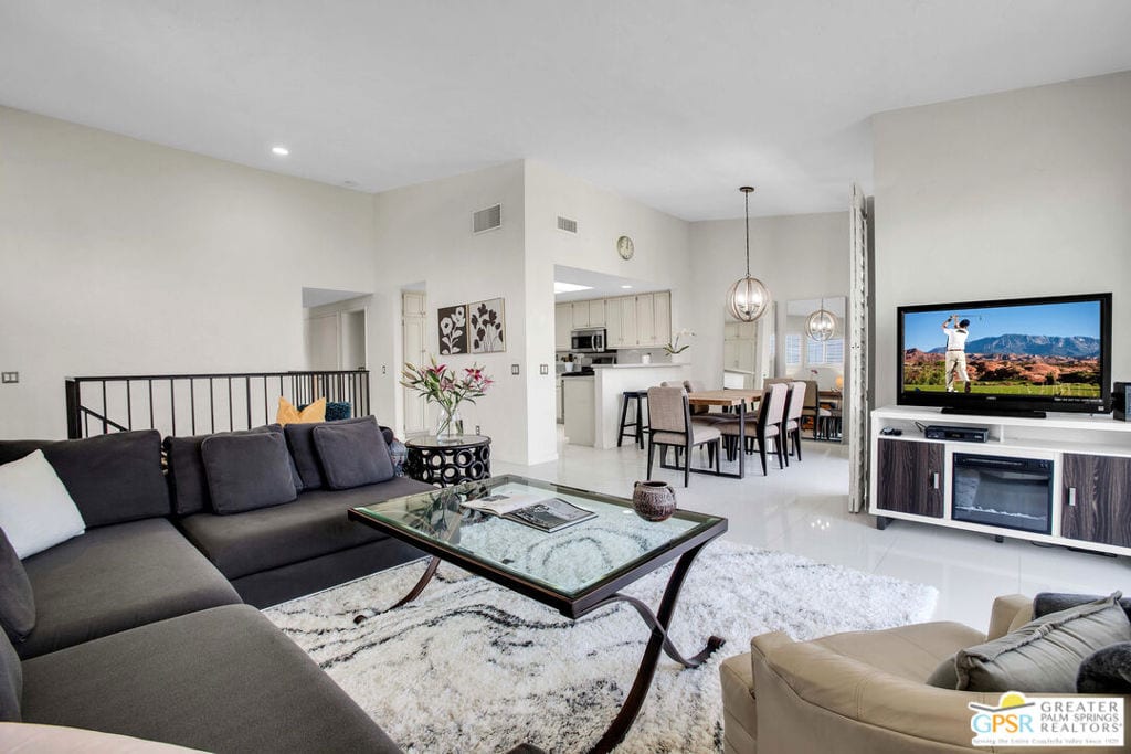 living room featuring light tile patterned floors and a notable chandelier