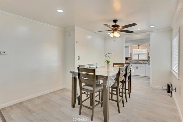 dining space with ceiling fan, light hardwood / wood-style flooring, and ornamental molding