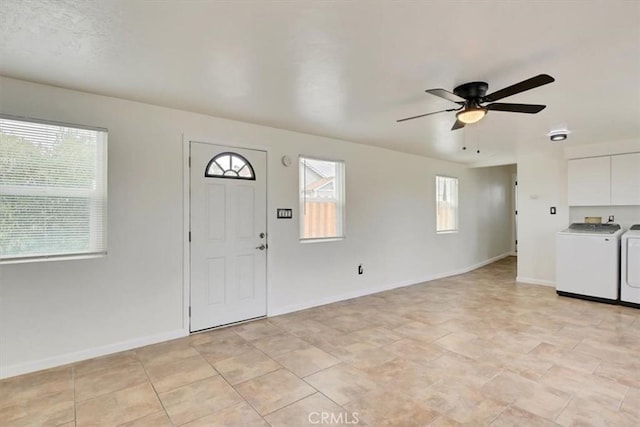 entryway featuring ceiling fan, washer and clothes dryer, and plenty of natural light