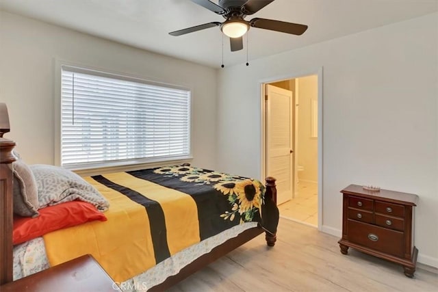 bedroom featuring ceiling fan, light hardwood / wood-style floors, and ensuite bathroom