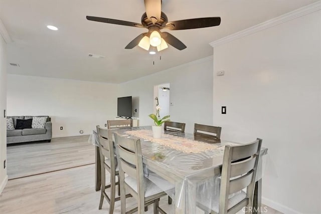 dining area with ceiling fan, ornamental molding, and light hardwood / wood-style flooring