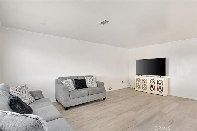 living room featuring light hardwood / wood-style floors and crown molding