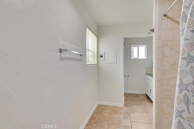 bathroom featuring walk in shower and tile patterned flooring