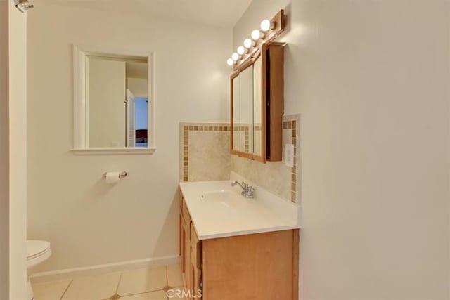 bathroom featuring toilet, tile patterned flooring, and vanity