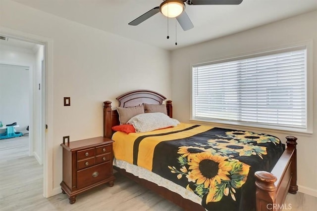 bedroom with ceiling fan and light hardwood / wood-style flooring