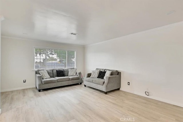 living room featuring light hardwood / wood-style floors and crown molding