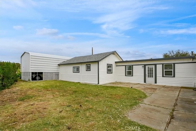 rear view of house featuring a lawn