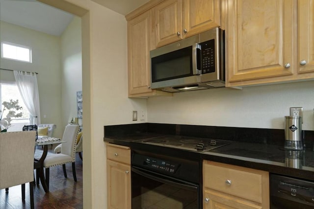 kitchen featuring dark hardwood / wood-style floors and black appliances