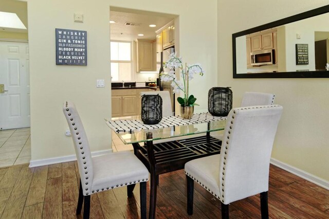 dining space featuring wood-type flooring and sink