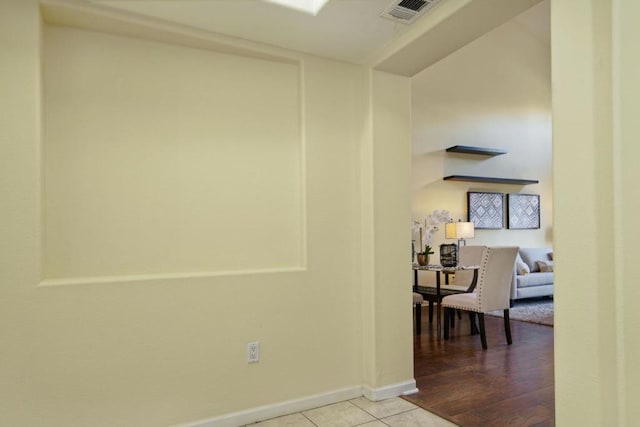 hall featuring light tile patterned floors