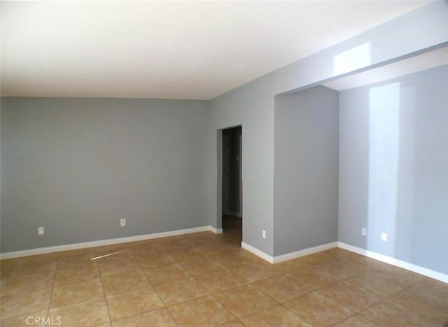 unfurnished room featuring light tile patterned flooring