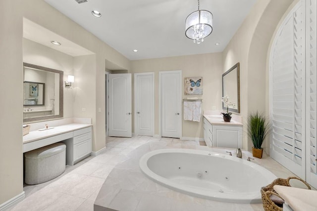 bathroom featuring tiled bath, tile patterned flooring, vanity, and a chandelier