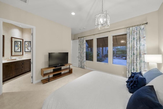 bedroom featuring light carpet, ensuite bathroom, and a notable chandelier