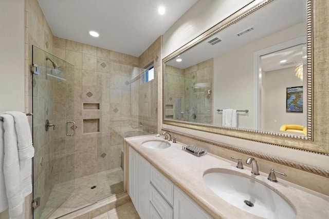 bathroom featuring tile patterned flooring, vanity, and walk in shower