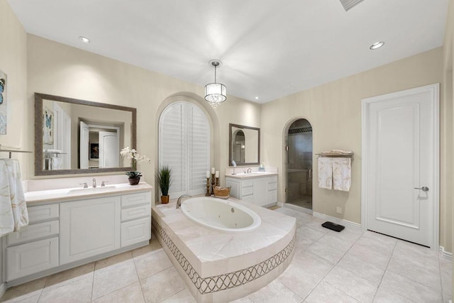 bathroom featuring tile patterned flooring, vanity, and plus walk in shower