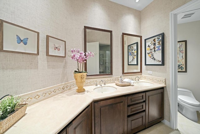 bathroom featuring tile patterned flooring, vanity, and toilet