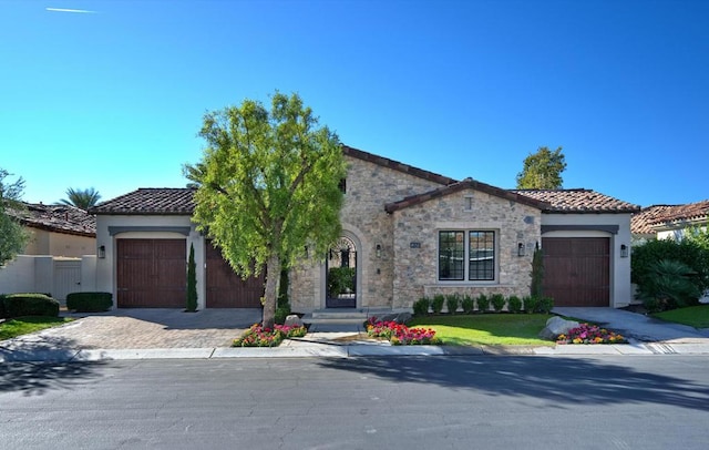 mediterranean / spanish home with a garage