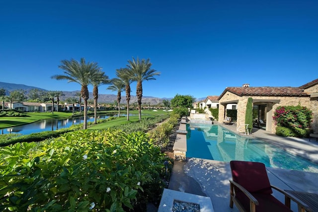 view of swimming pool featuring a water and mountain view