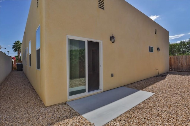 view of side of property featuring a patio area