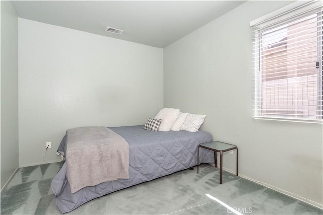 bedroom with light colored carpet