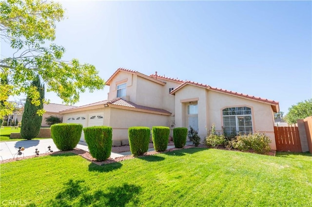 mediterranean / spanish home with a front lawn