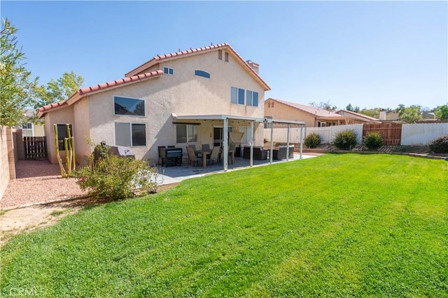 back of property featuring a lawn and a patio area